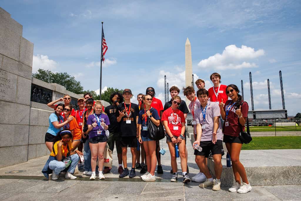 Scholars on the National Mall, with the Washington Monument behind them.